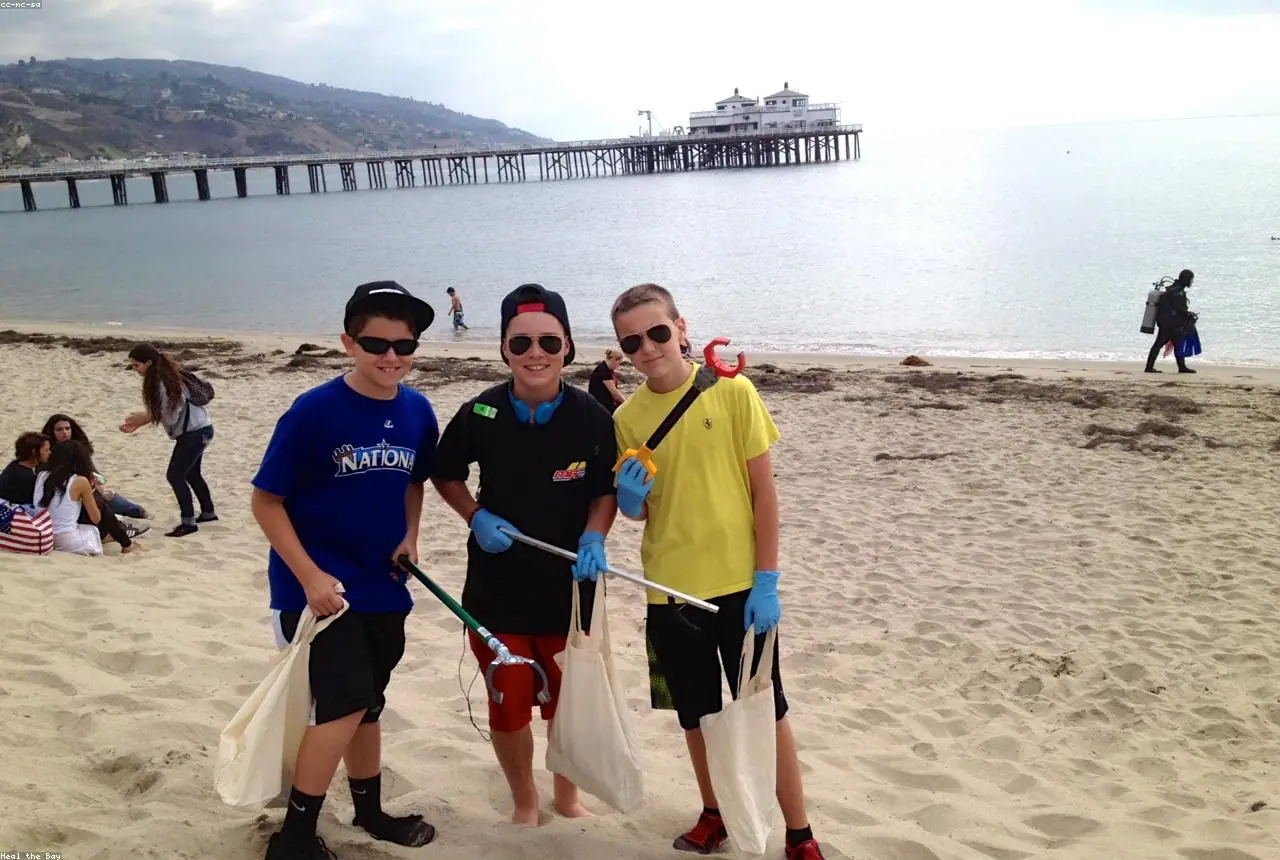 Volunteers cleaning up a beach at low tide